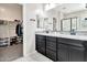 Elegant bathroom with dual sinks, granite countertops, and a walk-in closet at 25583 S 224Th Pl, Queen Creek, AZ 85142