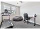 Inviting exercise room features a treadmill, a beanbag chair, a desk and natural light through the window at 25583 S 224Th Pl, Queen Creek, AZ 85142