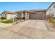 Single story home with a manicured lawn, stone accents, and a two-car garage in a desirable neighborhood at 25583 S 224Th Pl, Queen Creek, AZ 85142