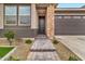 Front Entrance featuring a stone accent wall and a paved walkway leading to the front door at 25583 S 224Th Pl, Queen Creek, AZ 85142