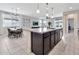 Open kitchen with stainless appliances, granite counters, dark cabinets, and a view of the dining area at 25583 S 224Th Pl, Queen Creek, AZ 85142