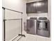 Well-equipped laundry room with modern washer, dryer, and upper cabinets at 25583 S 224Th Pl, Queen Creek, AZ 85142