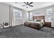 Bright main bedroom with large windows, carpet flooring, and neutral walls, offering a serene atmosphere at 25583 S 224Th Pl, Queen Creek, AZ 85142