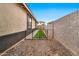 Practical side yard with artificial turf, rock landscaping and a fenced enclosure for pets at 25583 S 224Th Pl, Queen Creek, AZ 85142