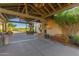 Inviting clubhouse entrance featuring covered walkway, decorative lighting, and desert landscaping at 26716 W Ponderosa Ln, Buckeye, AZ 85396