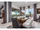 Dining room featuring modern chandelier, contemporary decor and view to the outdoor patio at 26716 W Ponderosa Ln, Buckeye, AZ 85396