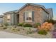 Charming stone accented single-story home featuring a desert landscape with cacti and native plants at 26716 W Ponderosa Ln, Buckeye, AZ 85396