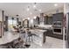 Open-concept kitchen with a center island, modern lighting, and stainless-steel appliances, perfect for entertaining at 26716 W Ponderosa Ln, Buckeye, AZ 85396