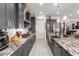 Open kitchen featuring gray cabinets, stainless steel appliances, and granite countertops at 26716 W Ponderosa Ln, Buckeye, AZ 85396