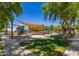 Colorful community playground with shade canopies, various play structures, and green space at 26716 W Ponderosa Ln, Buckeye, AZ 85396