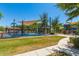 Gathering-friendly splash pad and playground with shade structures, bordered by manicured grass at 26716 W Ponderosa Ln, Buckeye, AZ 85396