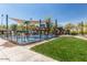 Fun splash pad area with water features, shaded seating, and playground equipment for Gathering enjoyment at 26716 W Ponderosa Ln, Buckeye, AZ 85396