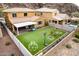 Aerial view of a home featuring a manicured backyard, covered patio, playground, and mountain views at 26868 N 104Th Ln, Peoria, AZ 85383