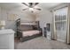 A bedroom with a ceiling fan, a window, bunk beds and carpet flooring at 26868 N 104Th Ln, Peoria, AZ 85383