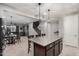 Kitchen island with granite countertop, views of staircase and living room at 26868 N 104Th Ln, Peoria, AZ 85383