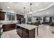 A kitchen with dark cabinetry and an island that has granite countertop at 26868 N 104Th Ln, Peoria, AZ 85383