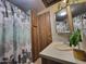 Bathroom with white countertop, mirror and floral shower curtain at 306 S Recker Rd # 212, Mesa, AZ 85206