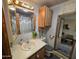 Well-lit bathroom featuring a vanity with sink and wooden cabinets for optimal storage solutions at 306 S Recker Rd # 212, Mesa, AZ 85206