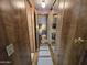 Hallway view to the bedroom with a decorative runner rug and a large mirror on the wall at 306 S Recker Rd # 212, Mesa, AZ 85206