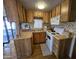 Open layout kitchen with tiled backsplash and breakfast bar with seating at 306 S Recker Rd # 212, Mesa, AZ 85206