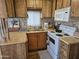 Functional kitchen with a light countertop, cabinetry, backsplash and white appliances at 306 S Recker Rd # 212, Mesa, AZ 85206