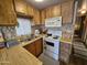 Functional kitchen with stainless steel sink, tiled backsplash, and convenient oven at 306 S Recker Rd # 212, Mesa, AZ 85206