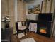 Comfortable living area featuring a fireplace, a TV, and soft, neutral-toned curtains at 306 S Recker Rd # 212, Mesa, AZ 85206