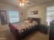 Bedroom with natural light, large bed, and matching nightstand at 3301 S Goldfield Rd # 4025, Apache Junction, AZ 85119