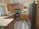 Bright kitchen featuring stainless steel appliances, updated cabinets, and laminate floors at 3301 S Goldfield Rd # 4025, Apache Junction, AZ 85119