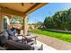 Inviting covered back patio with comfortable seating overlooks a well-maintained backyard at 3431 E Canary Ct, Chandler, AZ 85286