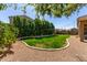 Serene backyard featuring lush green grass, decorative rock and manicured landscaping at 3431 E Canary Ct, Chandler, AZ 85286