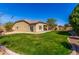 Spacious backyard boasts lush green grass, desert landscaping, and a well-maintained exterior at 3431 E Canary Ct, Chandler, AZ 85286