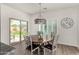 Cozy dining area with a round table, stylish chandelier, and backyard access at 3431 E Canary Ct, Chandler, AZ 85286