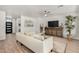 Cozy living room featuring a plush sofa, modern decor, and wood-look flooring at 3431 E Canary Ct, Chandler, AZ 85286