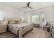 Light-filled main bedroom featuring wood floors, a bay window, and a ceiling fan at 3431 E Canary Ct, Chandler, AZ 85286