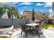 Backyard Patio features stone pavers, a dining set, and a view of the grassy backyard area at 3603 S Weaver E Cir, Gilbert, AZ 85297