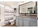 A well-lit bathroom showcases a dual-sink vanity with a dark-trimmed mirror and a tub with a shower at 3603 S Weaver E Cir, Gilbert, AZ 85297