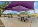 Community park seating area featuring park benches and picnic tables under a shade canopy at 3603 S Weaver Cir, Gilbert, AZ 85297