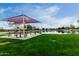 Community park featuring picnic tables under a shade canopy next to a scenic lake at 3603 S Weaver E Cir, Gilbert, AZ 85297