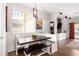 Cozy dining area with a wooden table, bench seating, and bright natural light at 3603 S Weaver Cir, Gilbert, AZ 85297