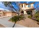 Charming two-story home showcasing manicured landscaping, a spacious driveway, and separate garage at 3603 S Weaver E Cir, Gilbert, AZ 85297