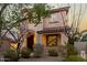 Inviting two-story home highlighting a cozy front porch, well-maintained landscaping, and unique architectural details at 3603 S Weaver Cir, Gilbert, AZ 85297