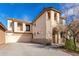 Beautiful two-story home featuring a large driveway, neutral stucco, and unique architectural details at 3603 S Weaver Cir, Gilbert, AZ 85297