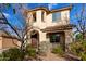 Inviting two-story home highlighting a cozy front porch, well-maintained landscaping, and unique architectural details at 3603 S Weaver Cir, Gilbert, AZ 85297