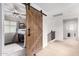 This hallway features a sliding barn door leading to a bedroom with a loft bed at 3603 S Weaver Cir, Gilbert, AZ 85297