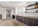 This hallway features built-in cabinets with countertops and open shelves at 3603 S Weaver E Cir, Gilbert, AZ 85297