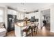 Stylish kitchen with white cabinets, granite counters, black appliances and an island at 3603 S Weaver E Cir, Gilbert, AZ 85297