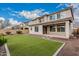 Backyard featuring artificial grass, covered patio, desert landscaping and block wall at 36076 N Vidlak Dr, San Tan Valley, AZ 85143