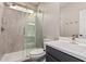 Bathroom featuring a walk-in shower with sliding glass doors and a modern sink with great light at 36076 N Vidlak Dr, San Tan Valley, AZ 85143