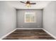 An empty bedroom with a ceiling fan, hardwood floors, and a window at 36076 N Vidlak Dr, San Tan Valley, AZ 85143